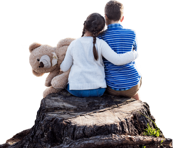 brother and sister hugging on a tree stump