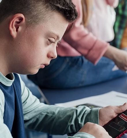 teenage boy looking at a mobile phone