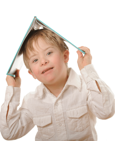 Child with Down syndrome holding a book over his head