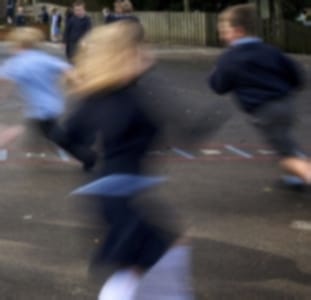 children racing past camera in school playground