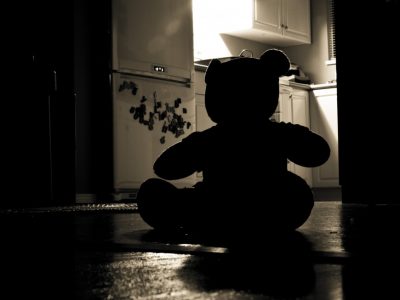 silhouette of teddy bear in a kitchen in the dark