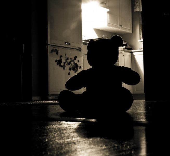 silhouette of teddy bear in a kitchen in the dark