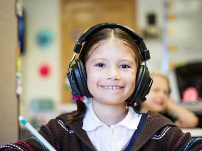 Girl wearing headphones at school