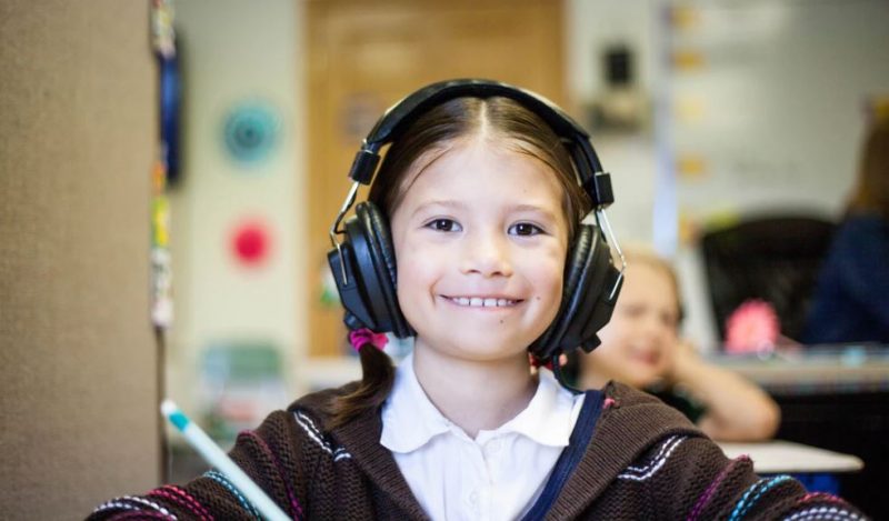 Girl wearing headphones at school