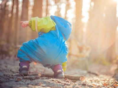 Toddler playing in the woods