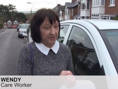 Wendy works as a carers in an agency she is pictured by her car who uses the current parking permit scheme