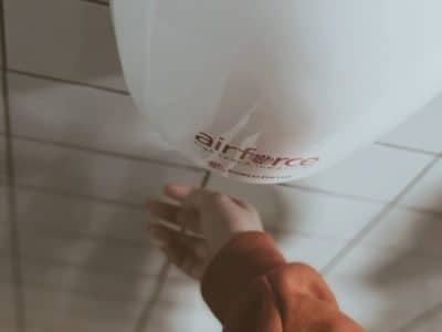 Child's hand using a hand drier in a toilet