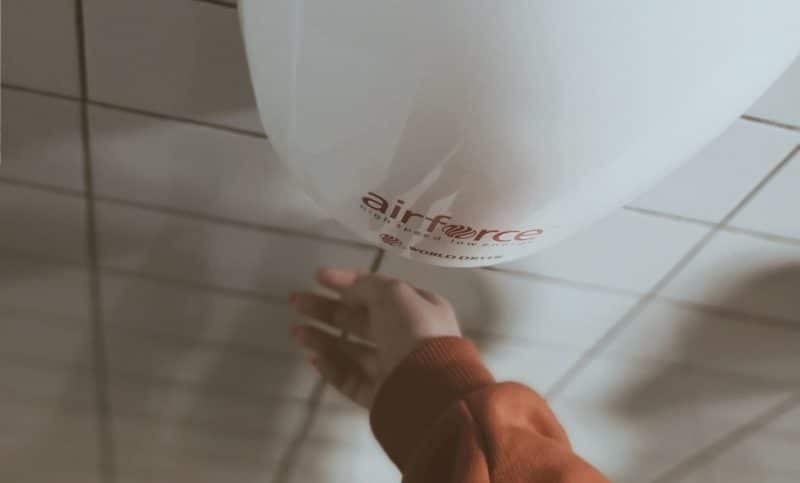 Child's hand using a hand drier in a toilet