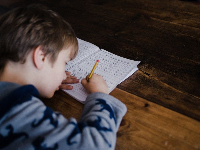 A boy doing homework at a desk