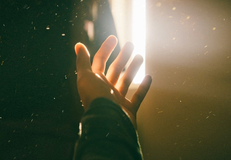 A hand reaching into the light