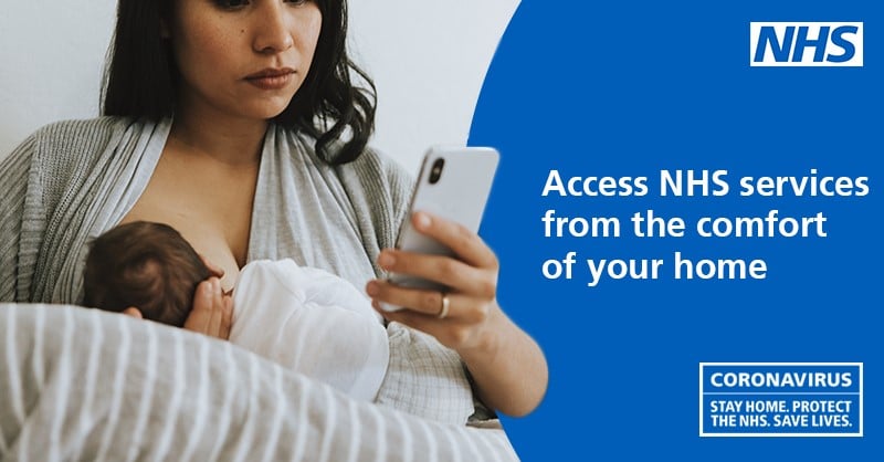 An NHS Health at Home poster. A woman holding a baby while checking her mobile phone.