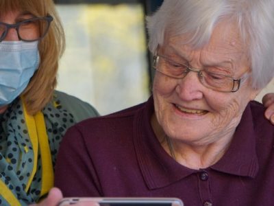 a key worker and an older woman share a touching moment