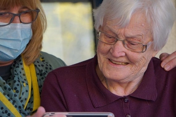 a key worker and an older woman share a touching moment