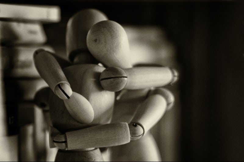 Two wooden manikins hugging