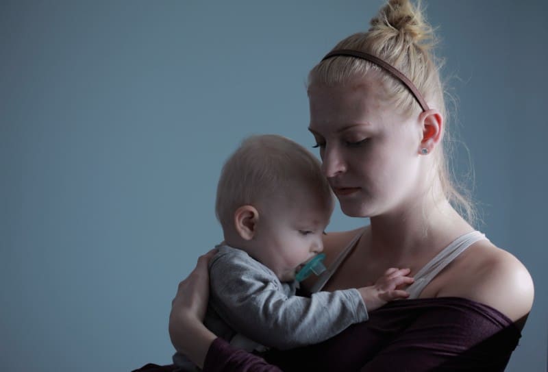 A mother holding her baby