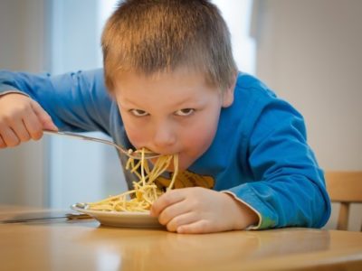 a child eating spaghetti