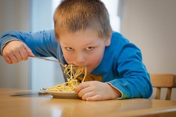 a child eating spaghetti