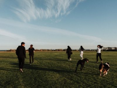 a group of young people walking across a field