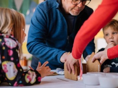 a family making a gingerbread house