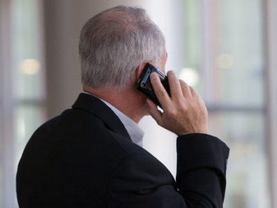 a man holding a mobile phone to his ear