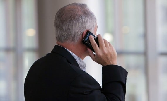 a man holding a mobile phone to his ear