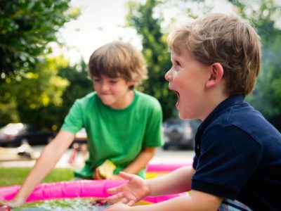 a boy in a paddling pool