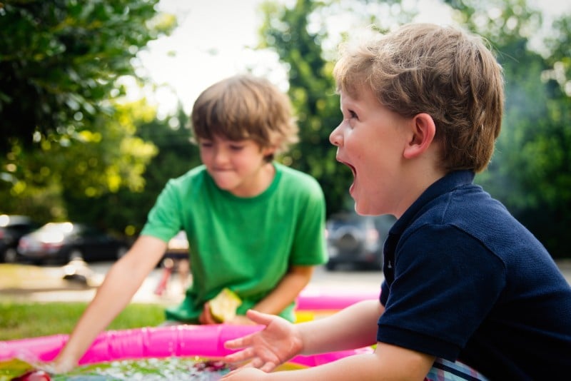 a boy in a paddling pool