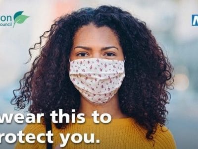 a woman wearing a face mask. The wording says: I wear this to protect you.