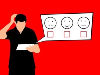 an illustration of a person looking at a survey with three options denoted by a sad face, a happy face and a neutral face