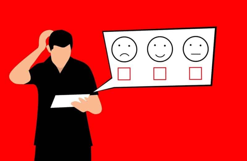 an illustration of a person looking at a survey with three options denoted by a sad face, a happy face and a neutral face