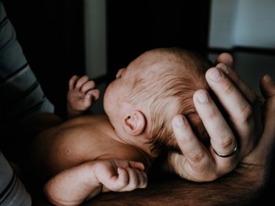 a parent holding a newborn baby