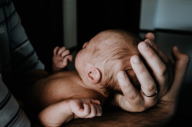 a parent holding a newborn baby