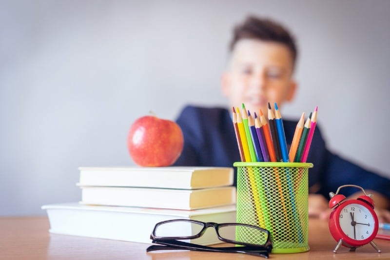 a boy looking at a tidy desk