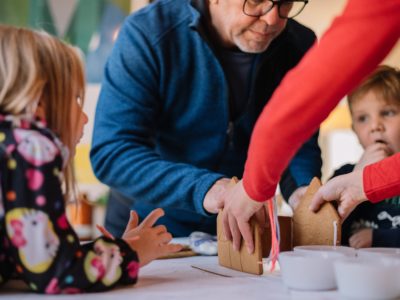 a family making a gingerbread house