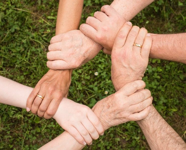 a circle of people holding hands