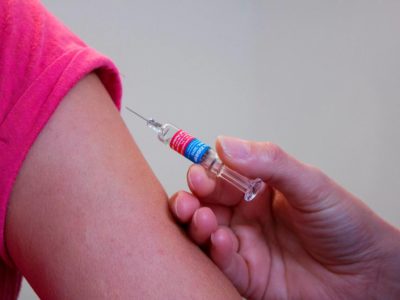 a person about to be injected with a vaccine