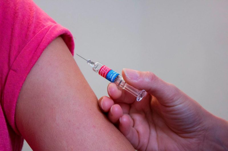 a person about to be injected with a vaccine