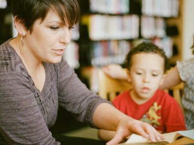 a women reading a book with a child