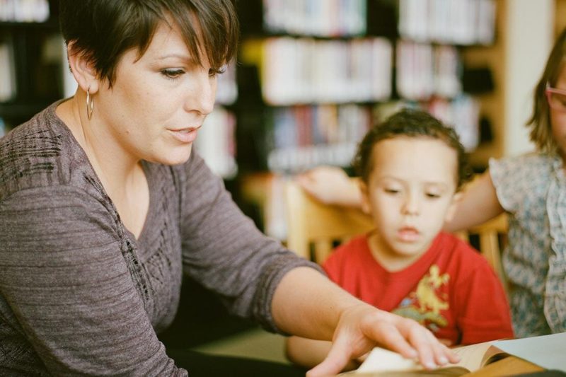 a women reading a book with a child