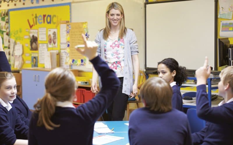 a teacher and her class of children