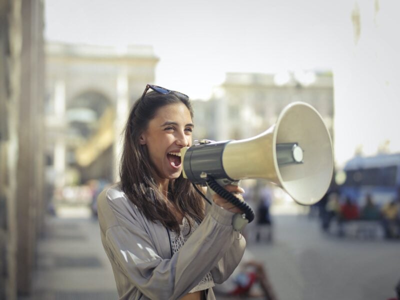 a woman speaking into a megaphone