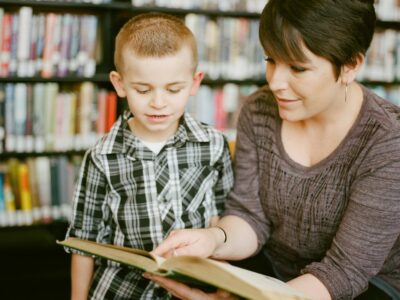 Adult and child reading a book