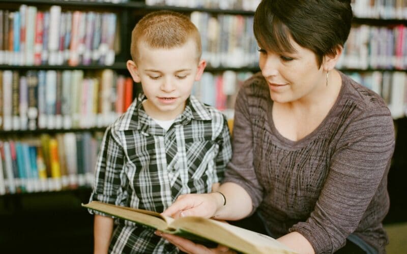 Adult and child reading a book