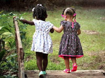 two children walking across a bridge