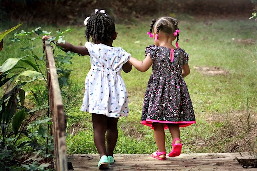 two children walking across a bridge