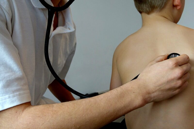 a doctor giving a child a health check