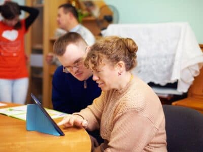 two friends with disability watching digital tablet