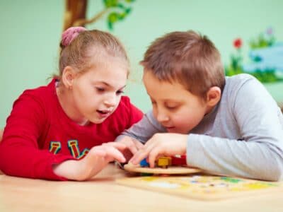 Children playing with a wooden toy