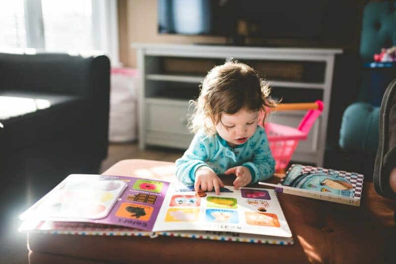 a photo of a toddler reading a book